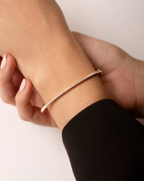 Classic Diamond Bangle in 14K Yellow Gold on model holding arm