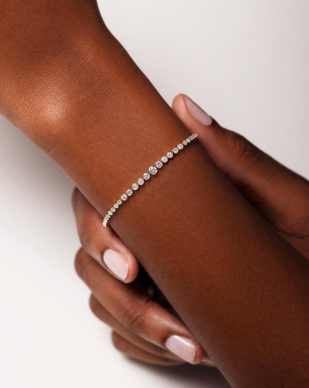 Graduated Bezel Diamond Tennis Bracelet shown on wrist of model