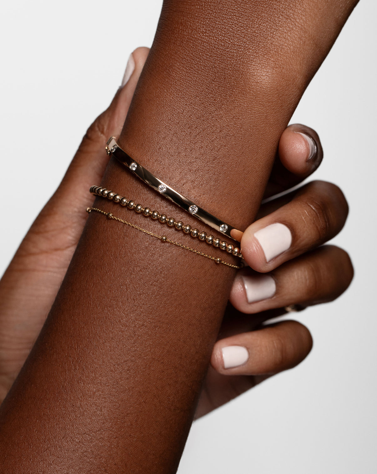 Ring Concierge Bracelets Petite Gold Bead Bracelet styled with Inlay Diamond Bangle and Saturn Chain Bracelet  