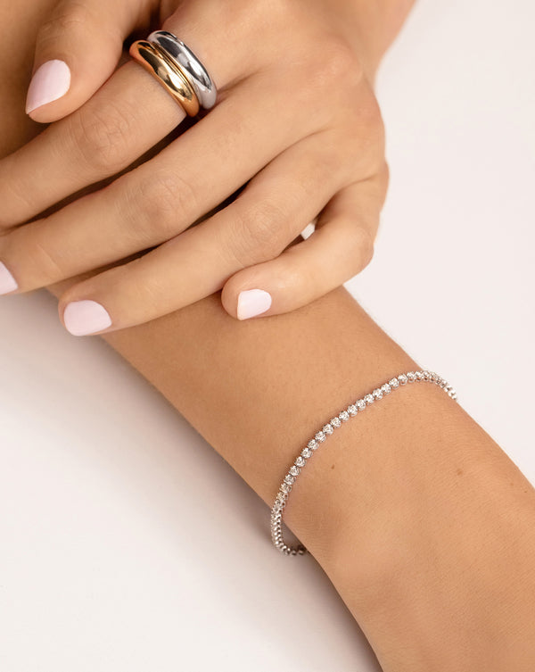 Model wearing Mini Diamond Tennis Bracelet on wrist with two Gold Cloud Rings