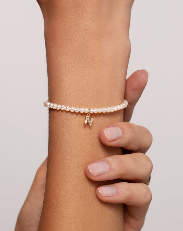 Close up image of the Pearl + Pavé Initial Bracelet shown on wrist