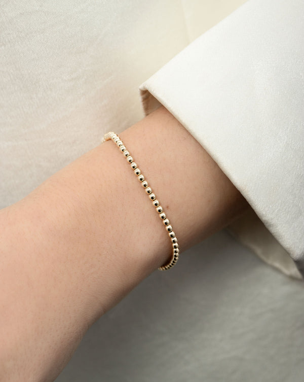 Petite Gold Bead Bracelet on model