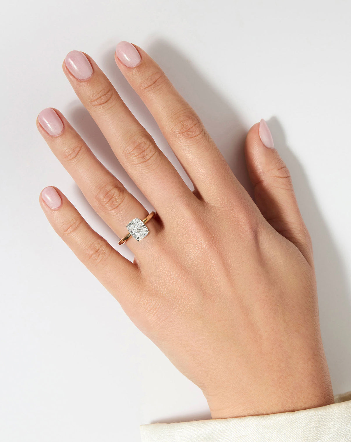 Cushion Diamond Cloud Solitaire Engagement Ring | 14k yellow gold w/ platinum prongs shown on hand