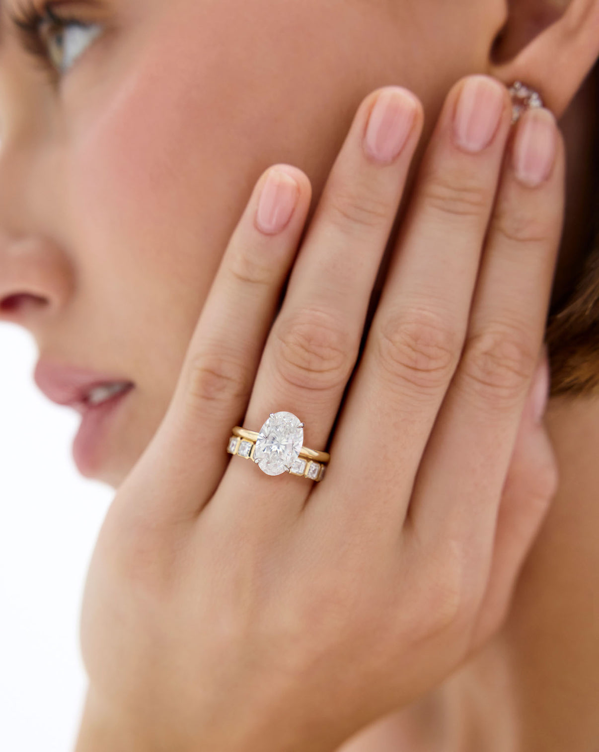 model wearing diamond band stacked with 4 carat Oval Diamond Cloud Solitaire Engagement Ring | 14k yellow gold w/ platinum prongs