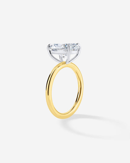 1 carat Round Diamond Engagement Ring in Yellow Gold Cloud Solitaire setting side angle showing the platinum prongs