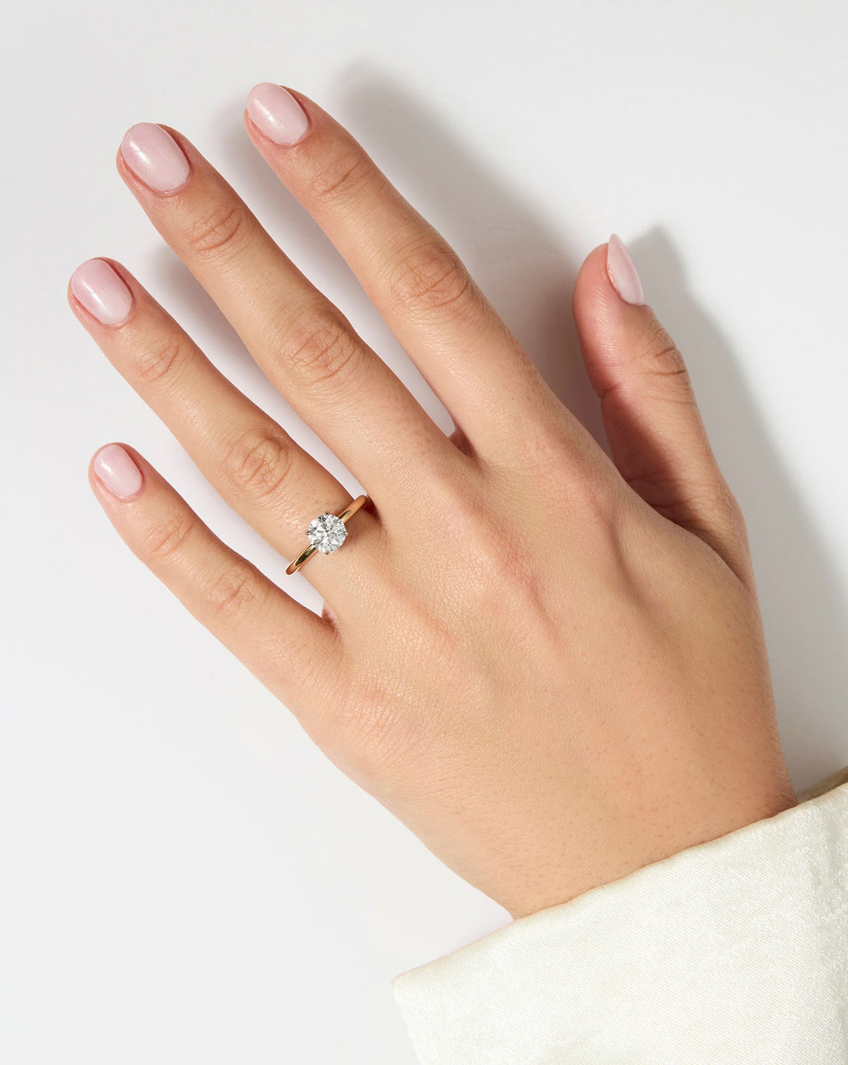 1 carat Round Diamond Engagement Ring in Yellow Gold Cloud Solitaire setting shown on model's hand