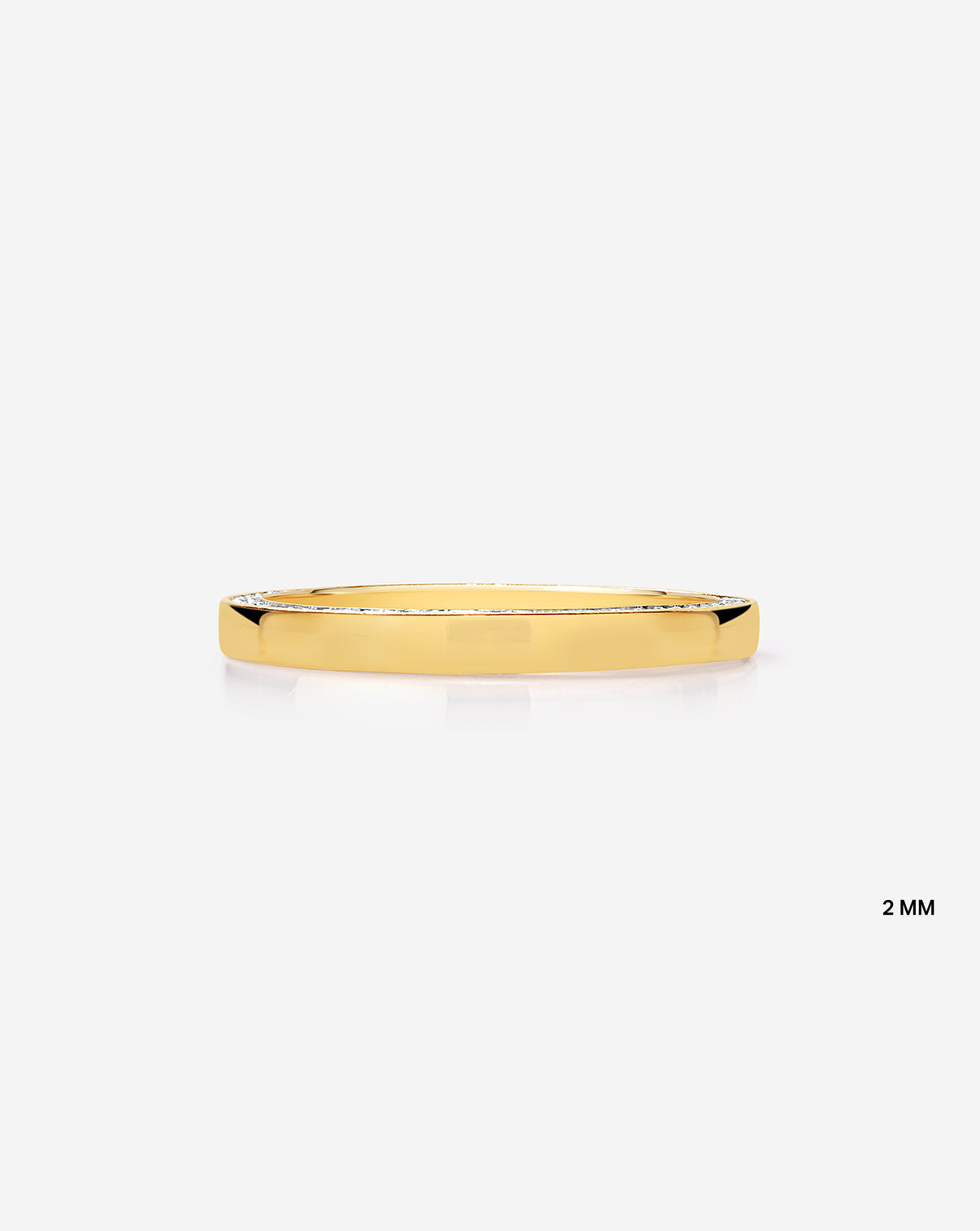 Flat lay of 2 mm brilliant pave cigar band in 14k Yellow Gold
