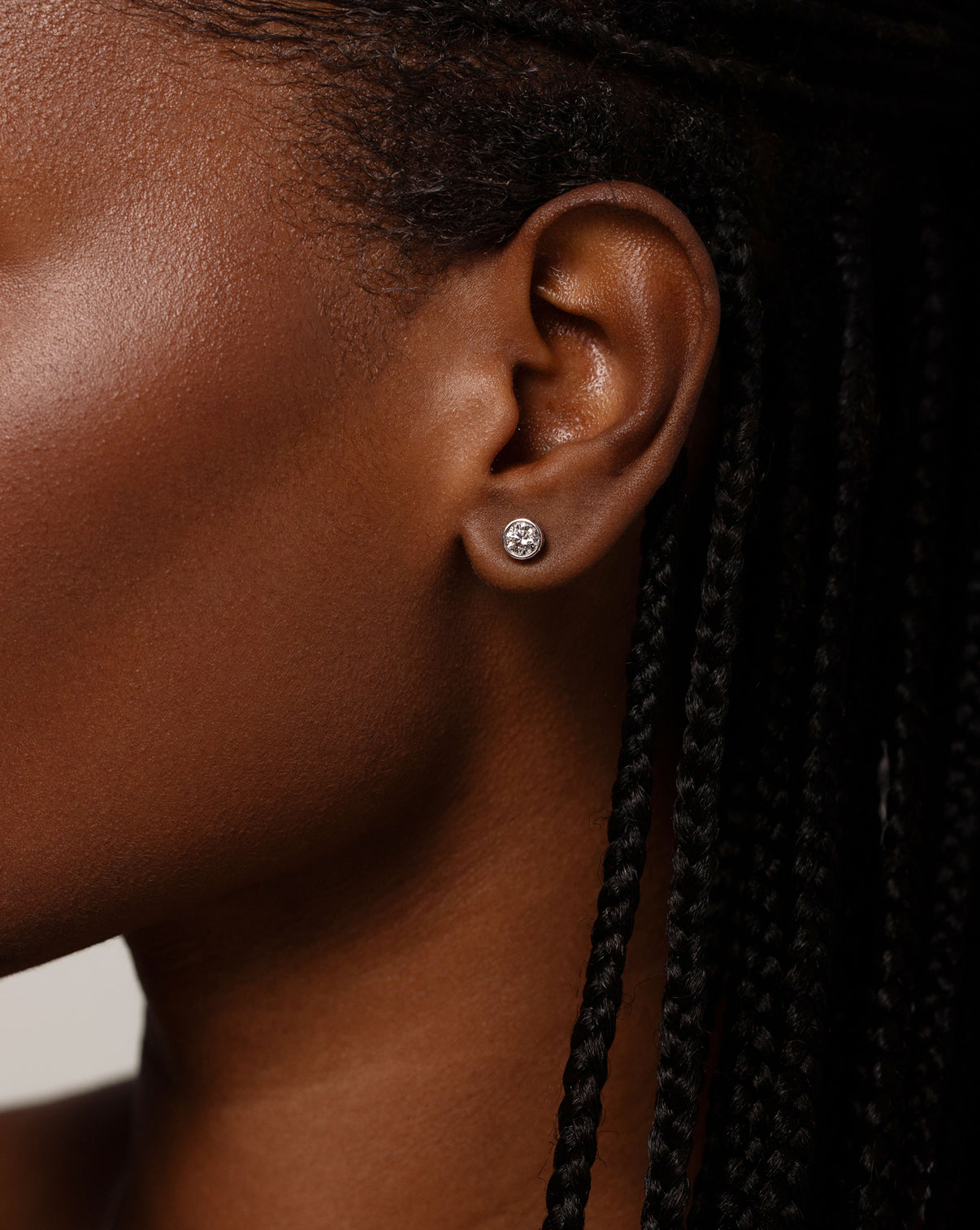 Bezel-Set Classic Diamond Studs in 14k white gold shown on ear of model