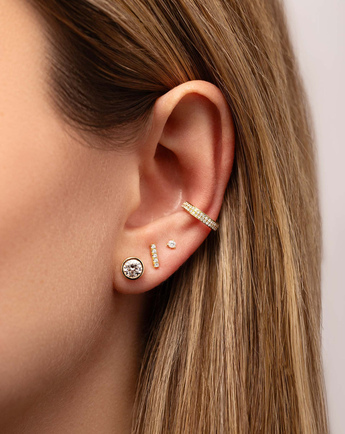 Bezel-Set Classic Diamond Studs styled with 3 other earrings on model