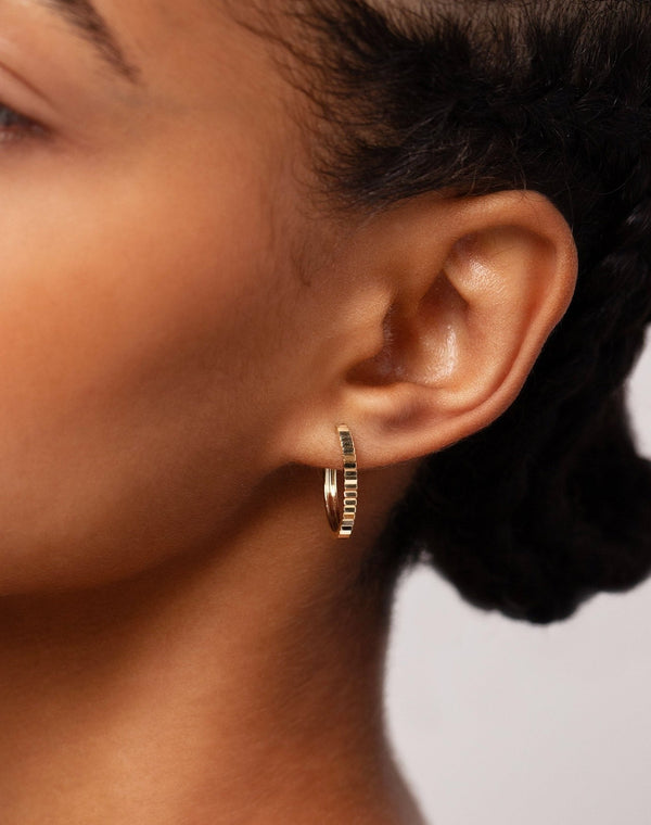 Fluted Gold Hoops shown on ear lobe of model