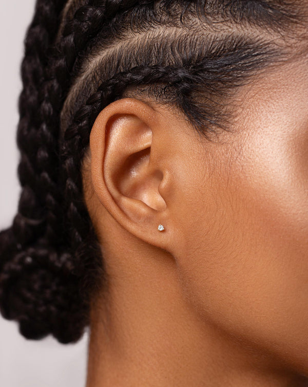 Close up image of Tiny Diamond Studs on ear of model