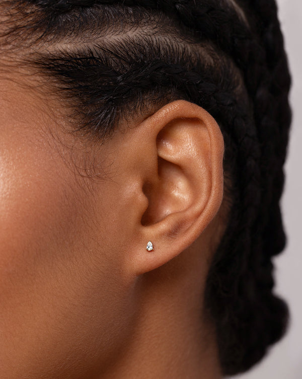 Close up image of the Tiny Pear Stud shown on ear of model