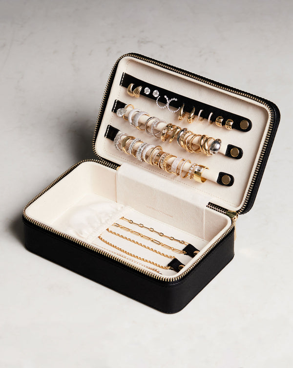 Multiway Leather Jewelry Case shown open and storing multiple earrings, rings and necklaces