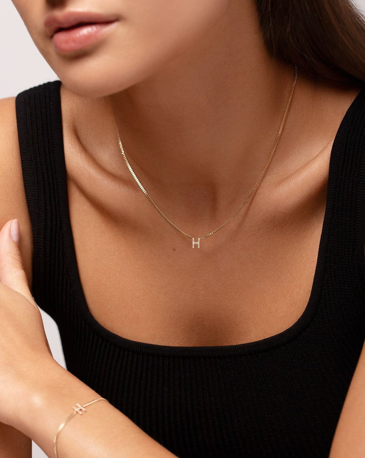 Diamond Initial Necklace letter H on model wearing black tank top