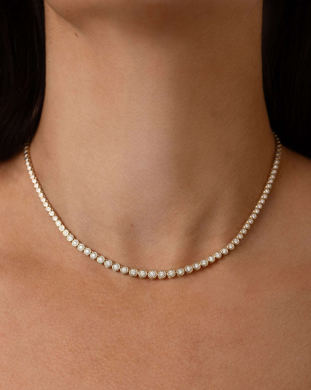 clear image of tennis necklace on-model global