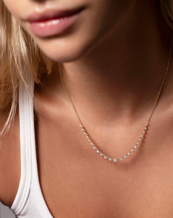 Graduated Diamond Layering Necklace shown in 14k yellow gold on neck of model