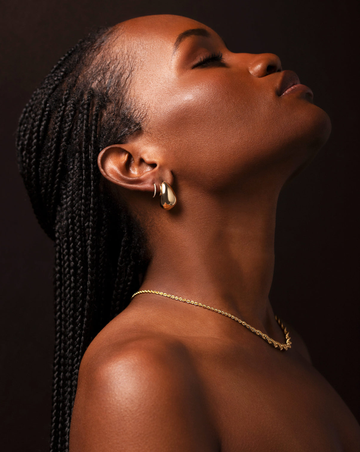 14k yellow bold gold cloud earrings, diamond huggie, and graduated gold rope chain necklace shown on model