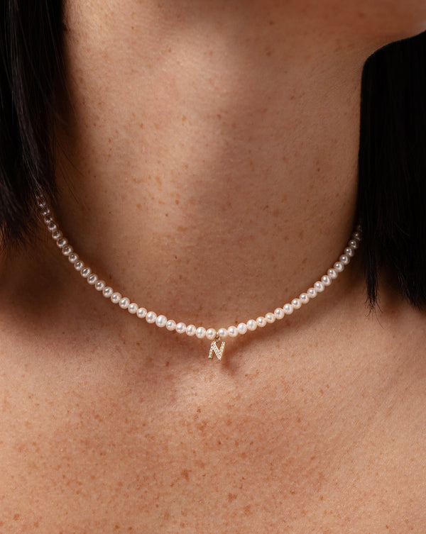 Pearl + Pavé Initial Choker letter N shown close up on model's neck.