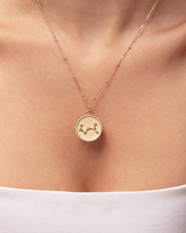 14k yellow gold zodiac constellation medallion necklace shown on model