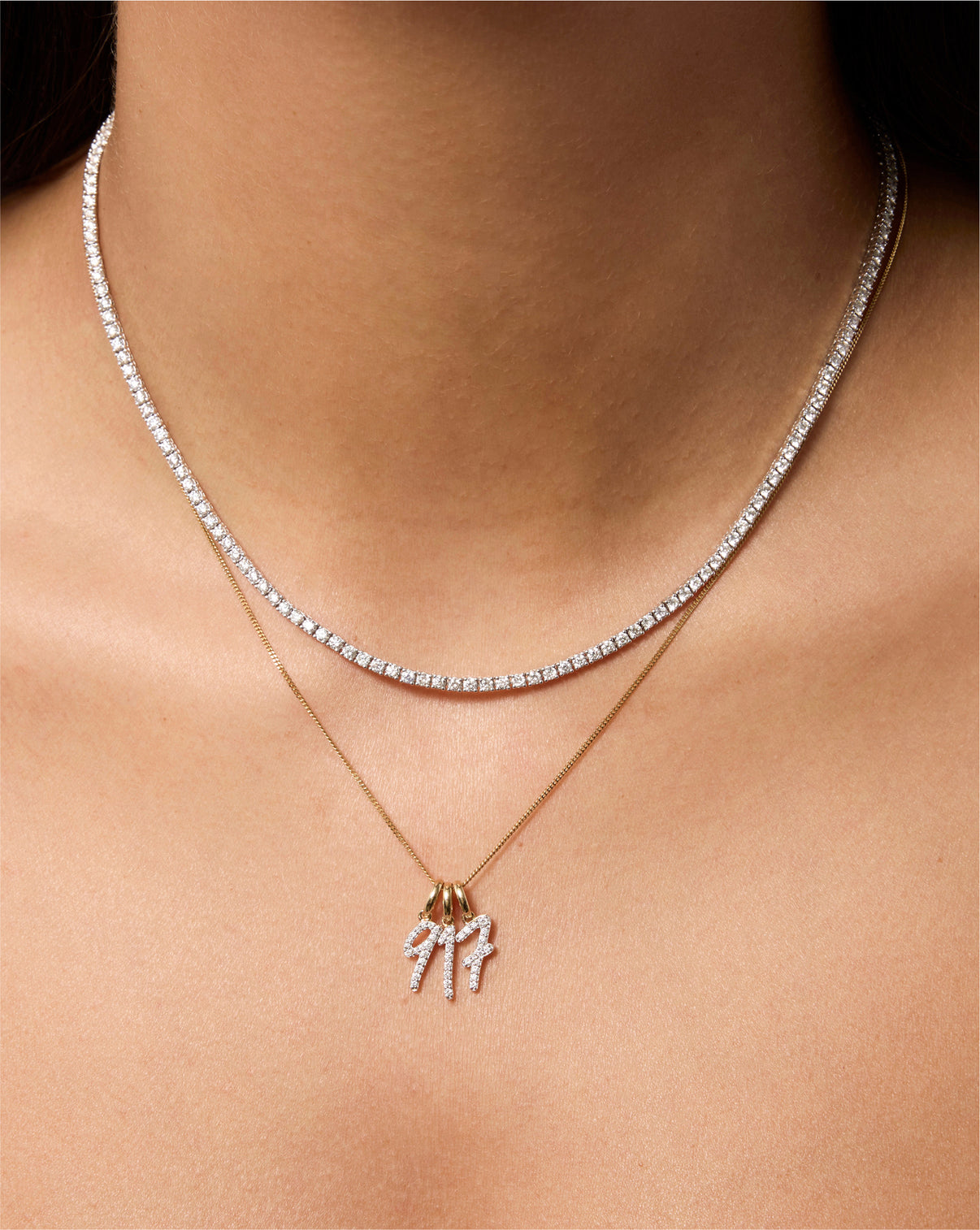 Diamond number pendant on chain necklace styled with tennis necklace and round pendant