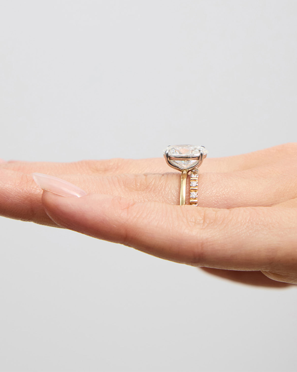 Fluted Diamond Ring side view on model's ring finger with engagement ring global