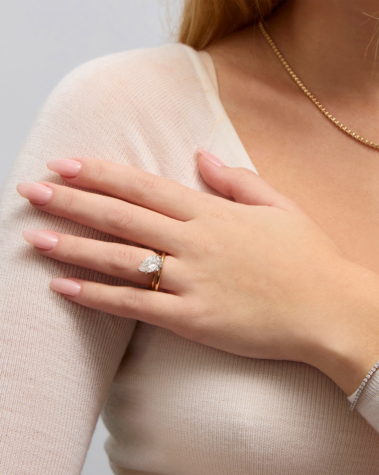 2 mm Cloud Band with Birthstone styled with pear shaped engagement ring