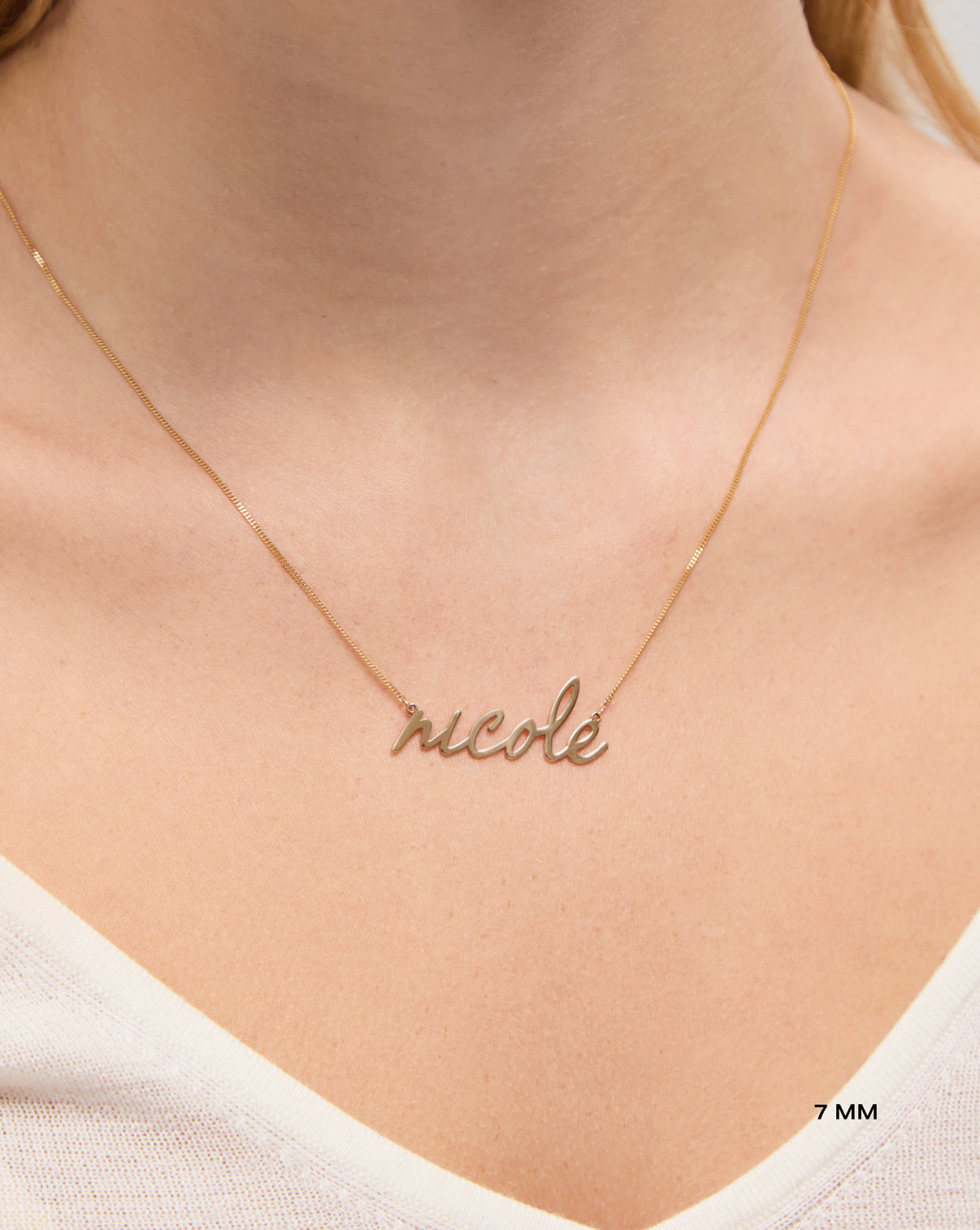 Personalized Script Name Necklace in yellow gold on model 7 mm