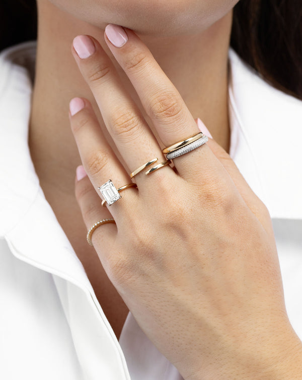 Petite Pavé Diamond Cloud Ring and Petite Gold Cloud Ring styled on model with 3 other gold rings.