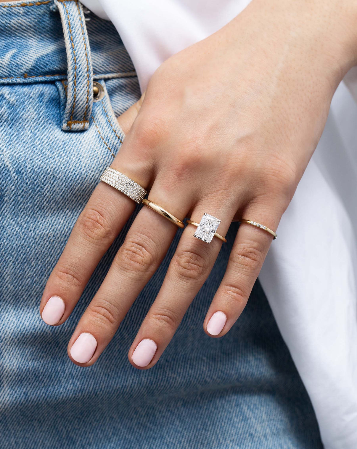 Five Row Stackable Pavé Ring styled with other rings on model wearing jeans 14k yellow gold