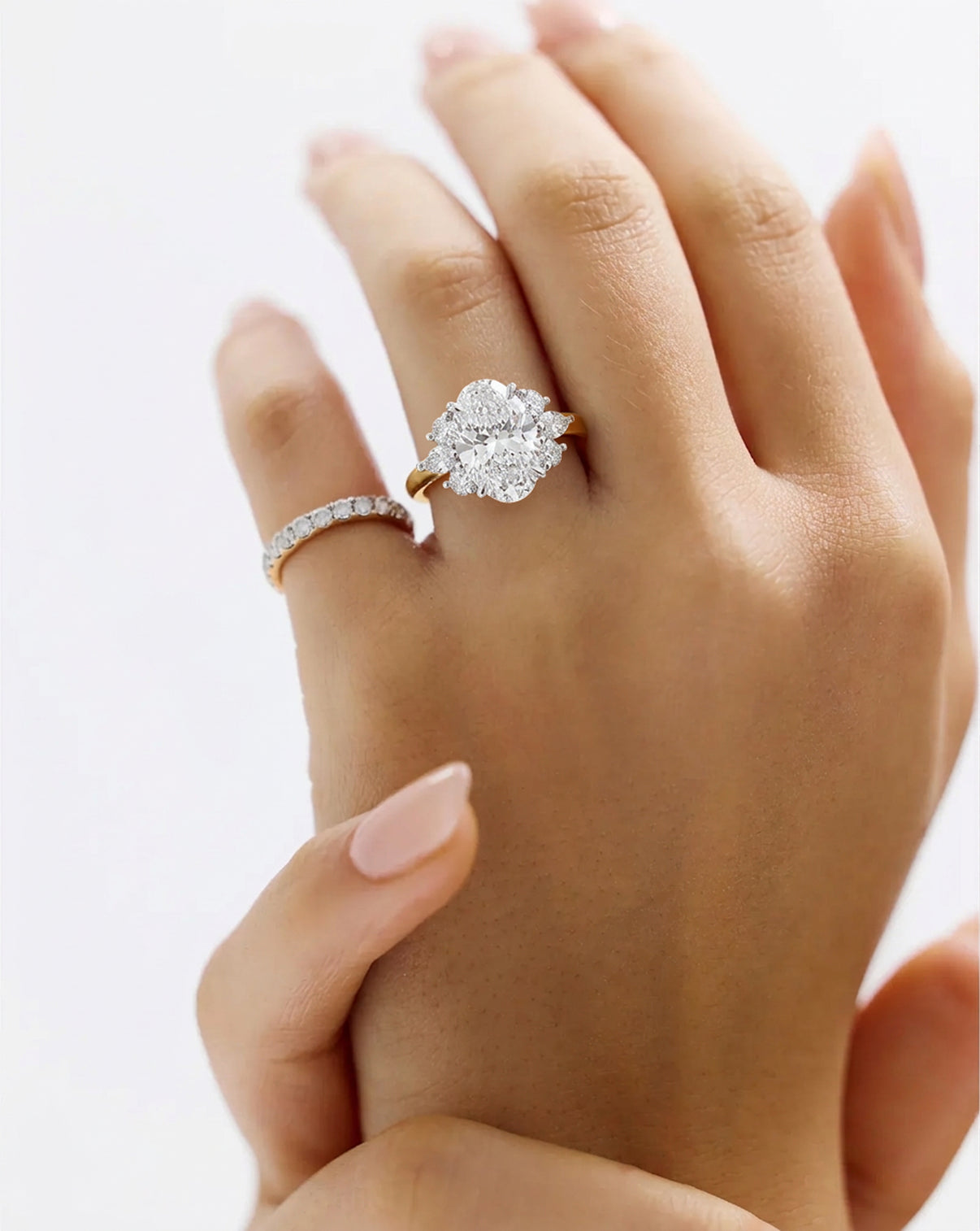 The Ivy Yellow Gold Engagement Ring shown on model with a pink ring 443934799331416 43934987092056 43934983258200