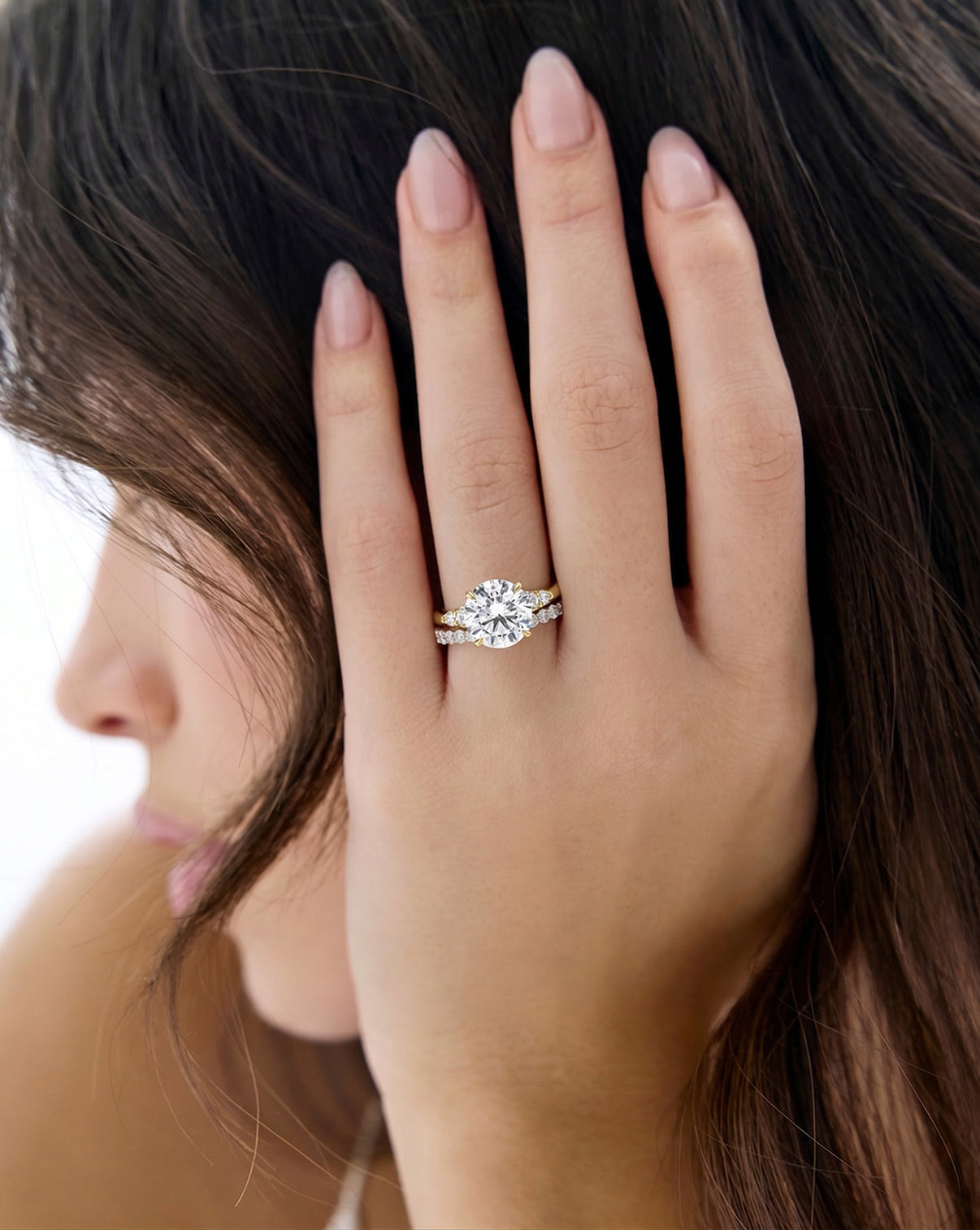 The Celeste
Yellow Gold Engagement Ring on model with a diamond band 43934988664920 43934798086232 43934985912408