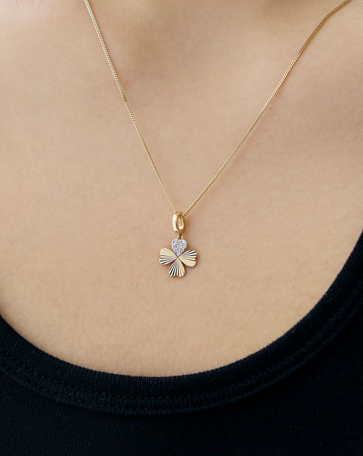 Clover charm on Yellow Gold Necklace worn on model 