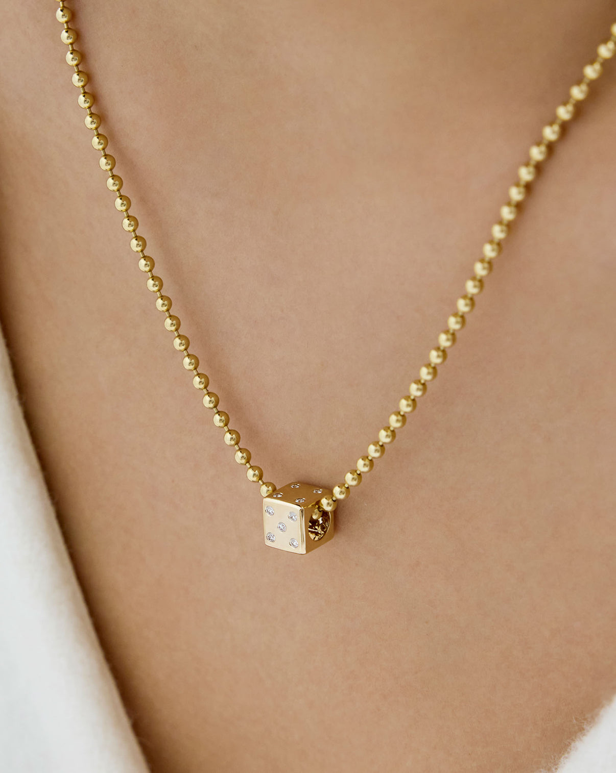 diamond dice bead charm with a bead necklace on model