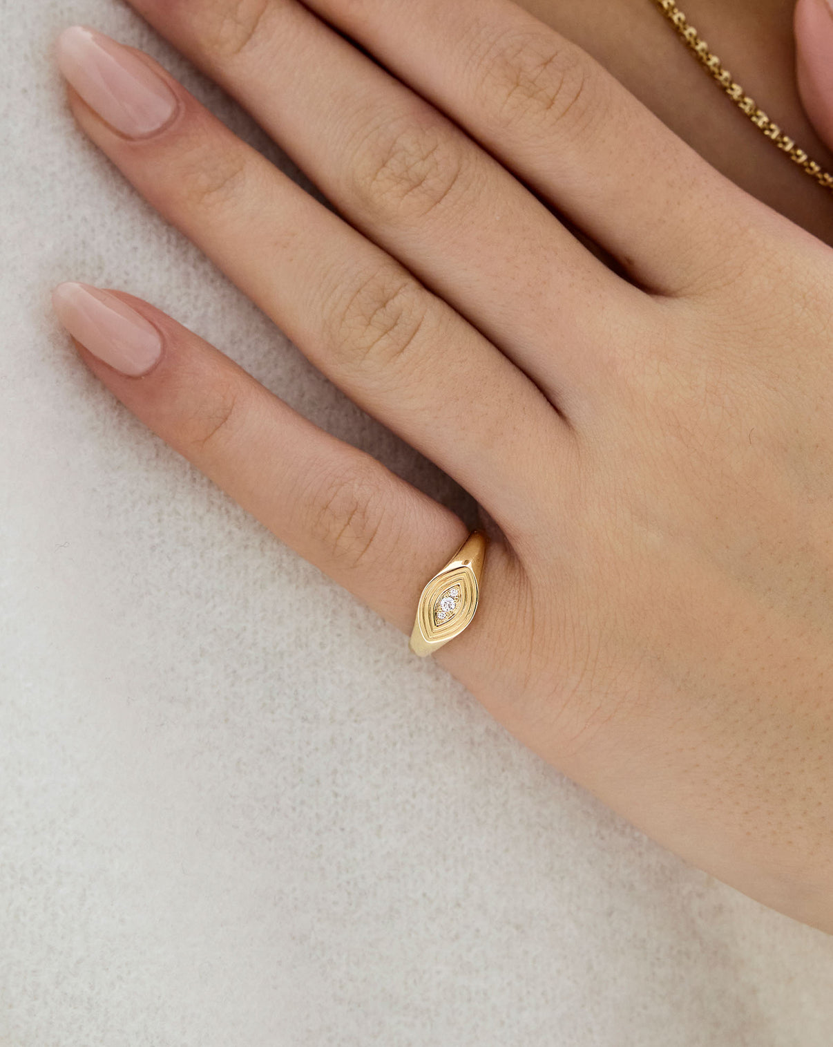 evil eye signet ring shown on finger