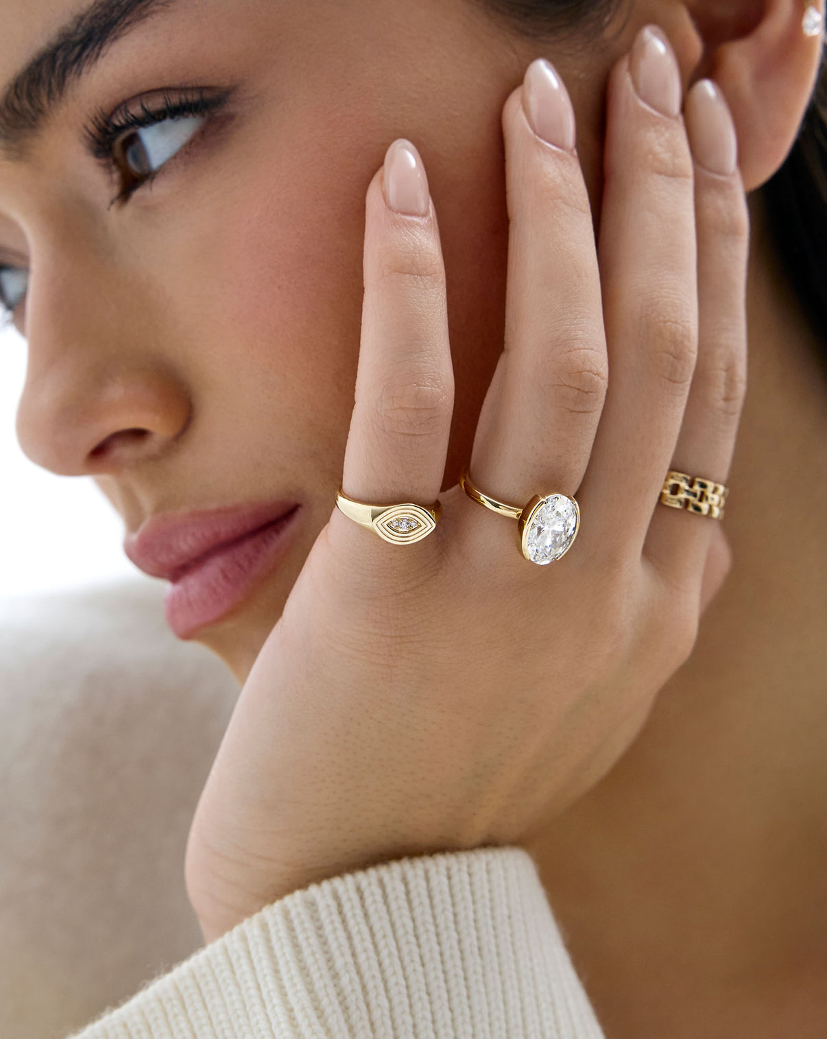 Evil Eye Signet Ring shown on model with various gold and diamond rings 