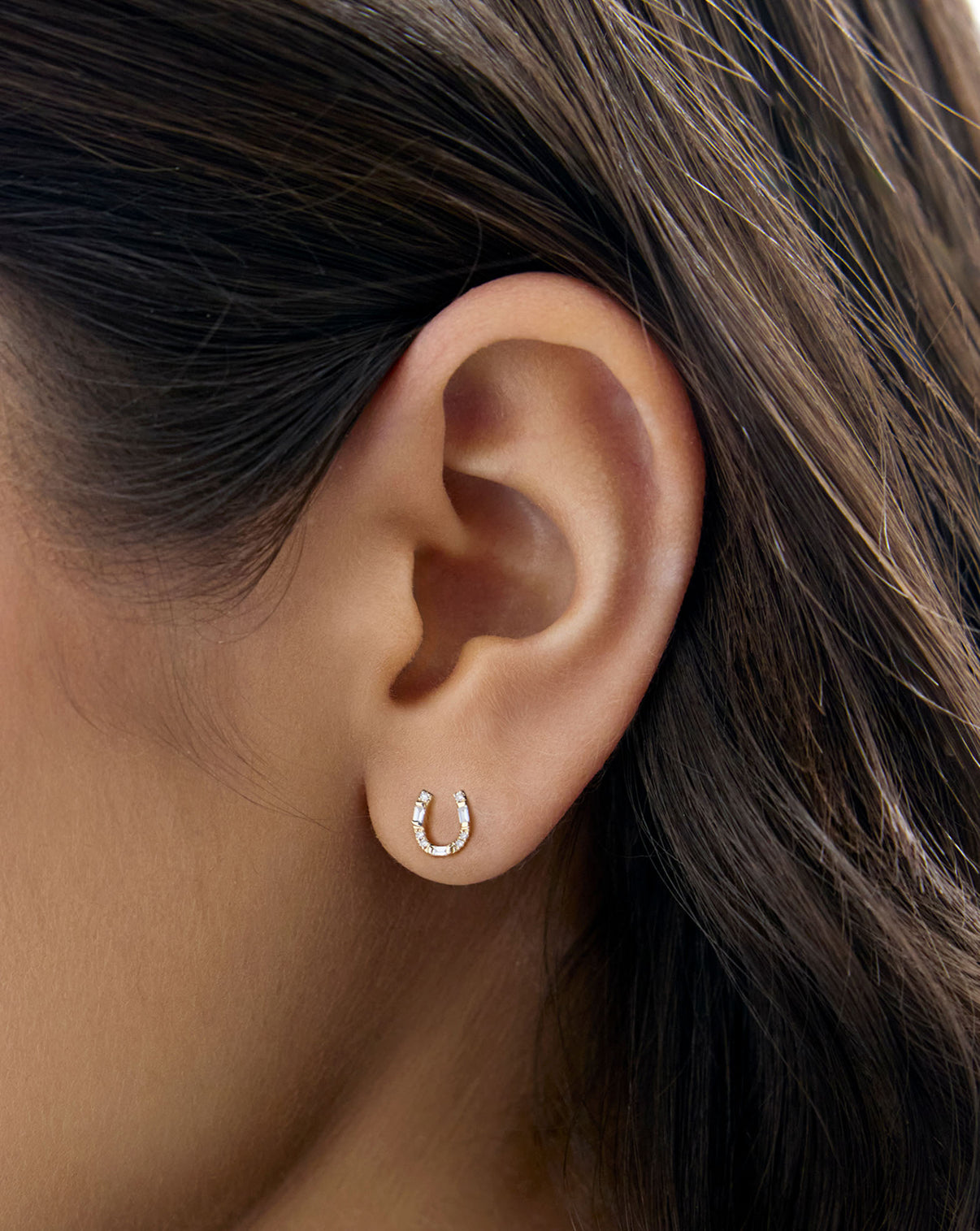 Horseshoe stud closeup on ear