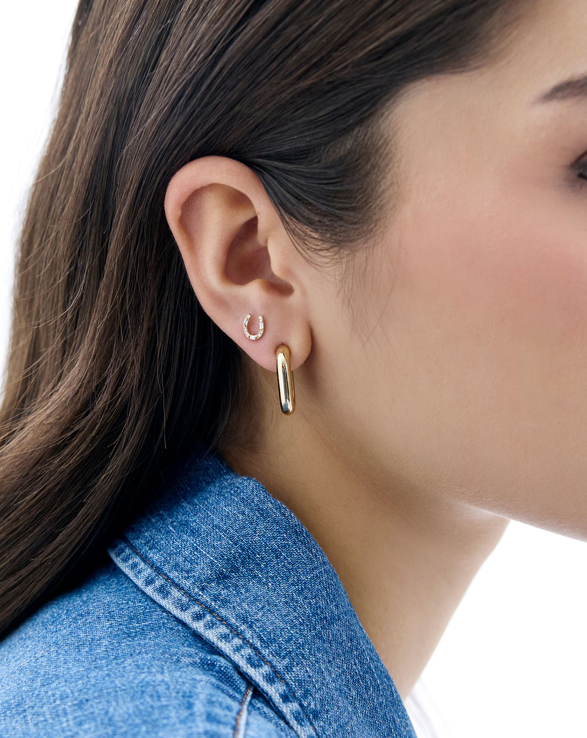 model wearing horseshoe stud with gold earring