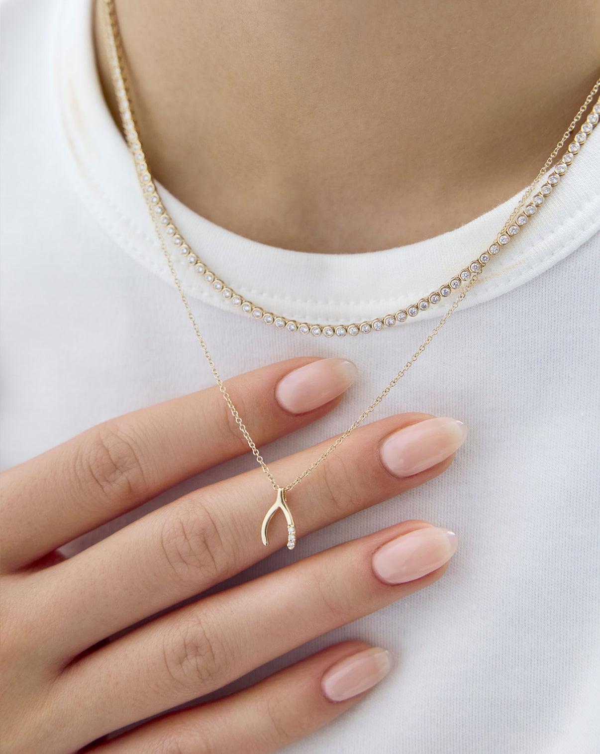 wishbone necklace shown on model with tennis necklace