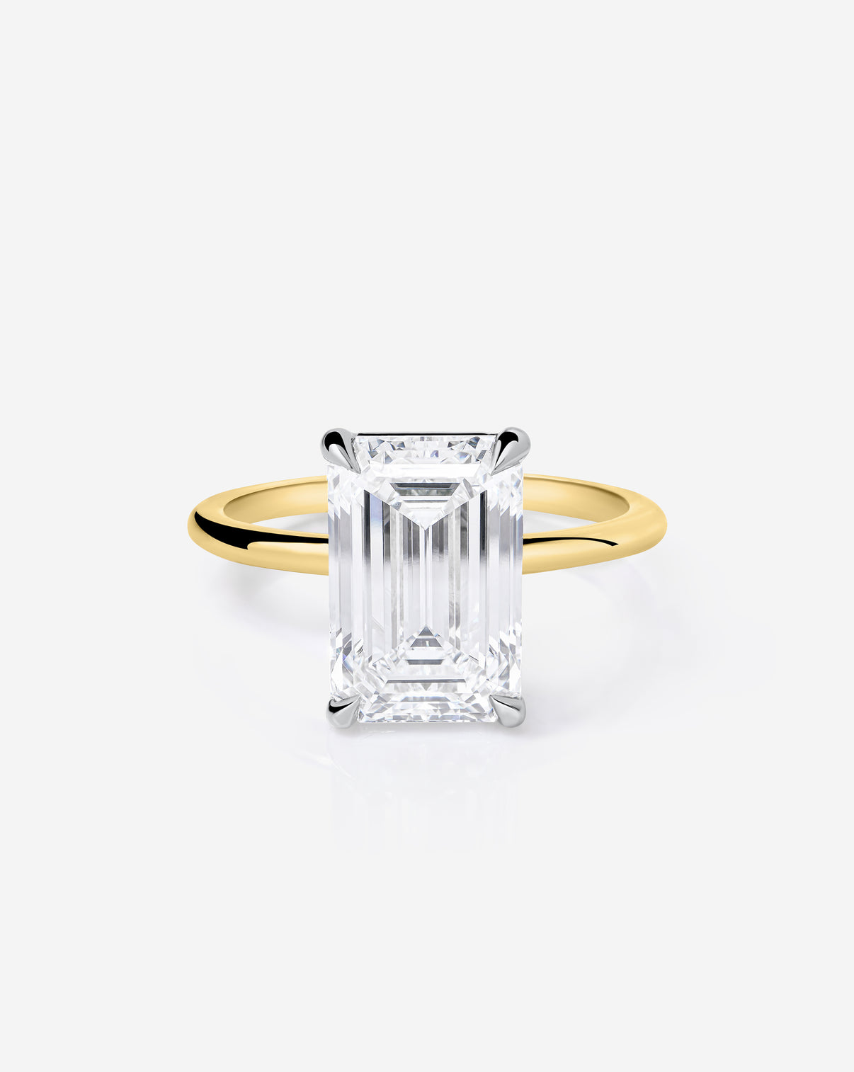 Close up 3.06 carat Emerald ring of the 5.21 Emerald & Pear Whisper Thin® Duet diamond Engagement ring in 14K Yellow Gold