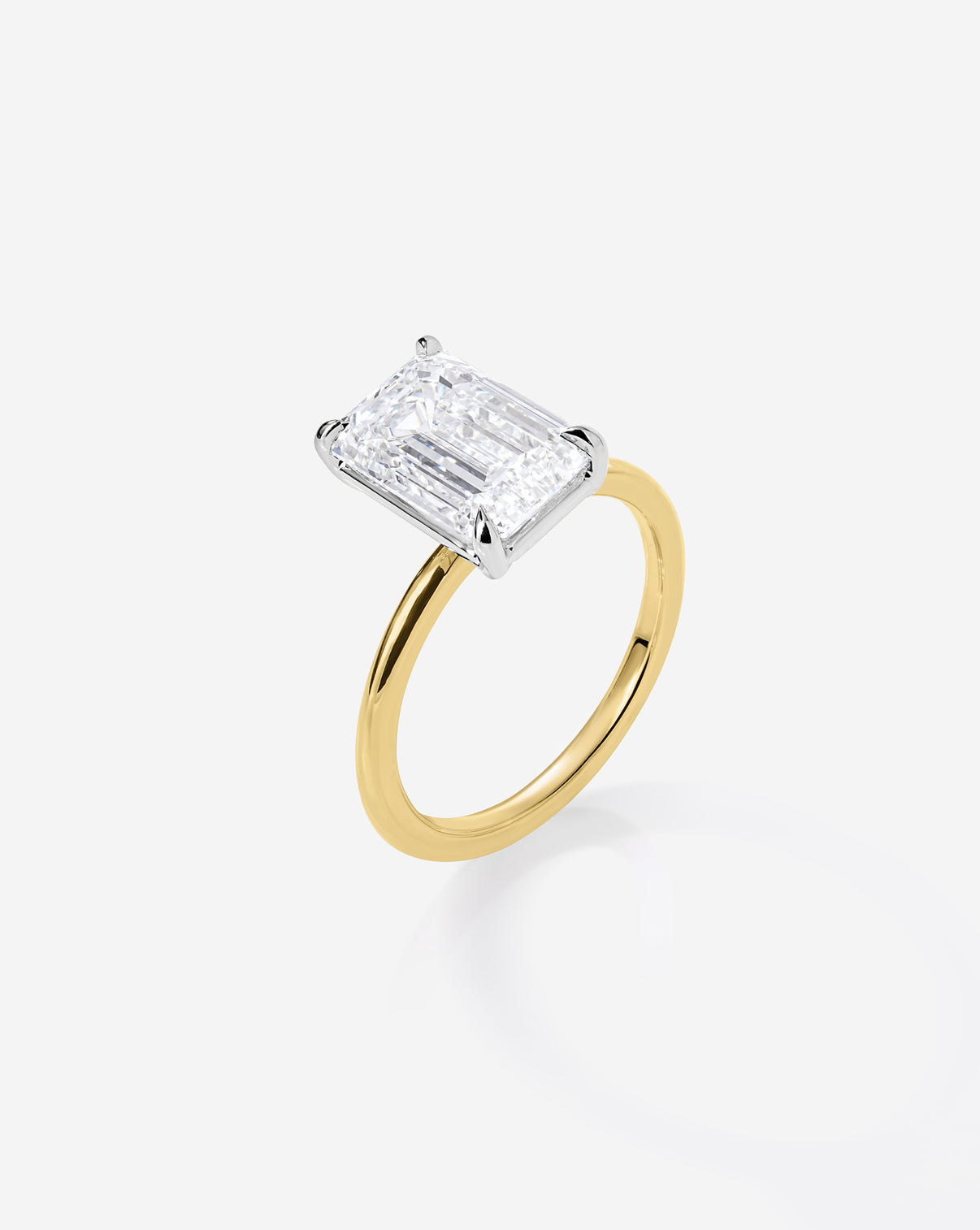 side view close up 3.06 carat Emerald ring of the 5.21 Emerald & Pear Whisper Thin® Duet diamond Engagement ring in 14K Yellow Gold