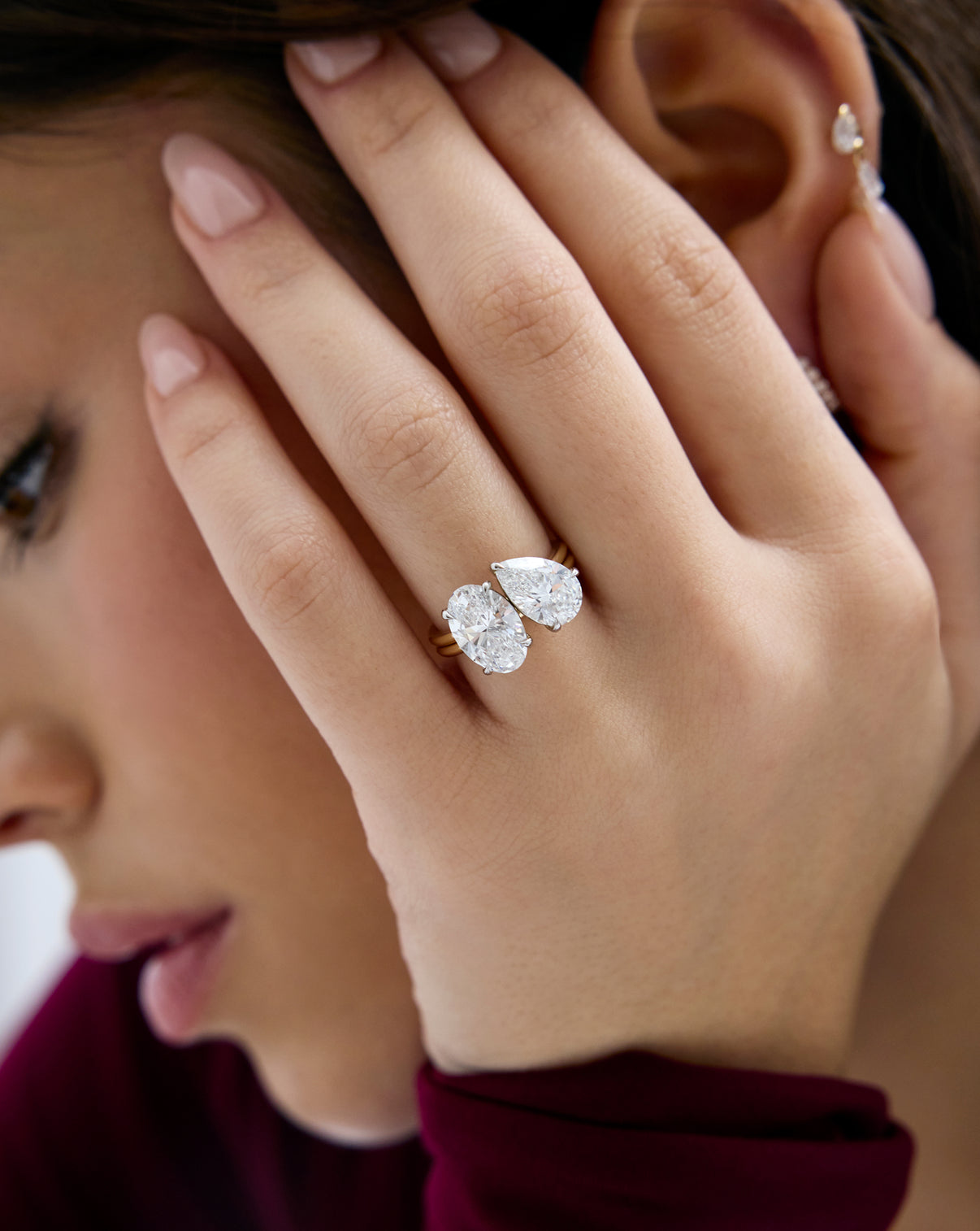 model wearing Stacked 4.70 Oval & Pear Whisper Thin® Duet diamond engagement ring in 14K Yellow Gold