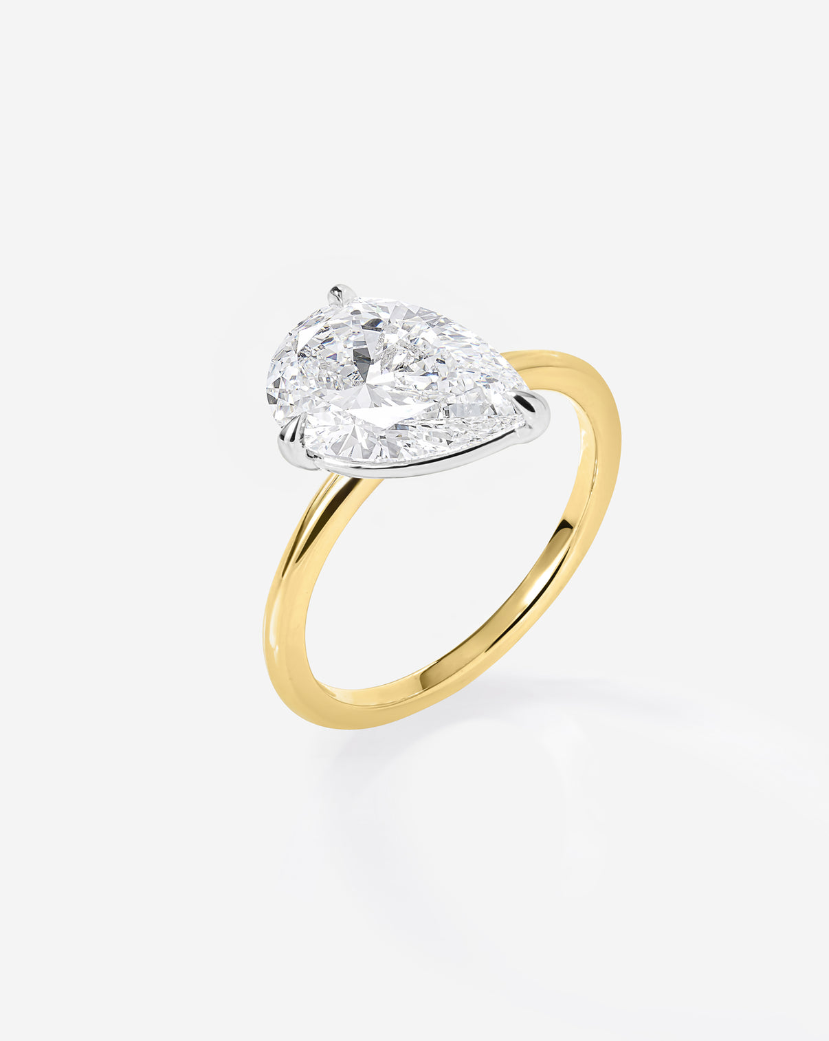 Close up side view of 2.17 carat Pear ring of the 4.70 Oval & Pear Whisper Thin® Duet diamond Engagement ring in 14K Yellow Gold