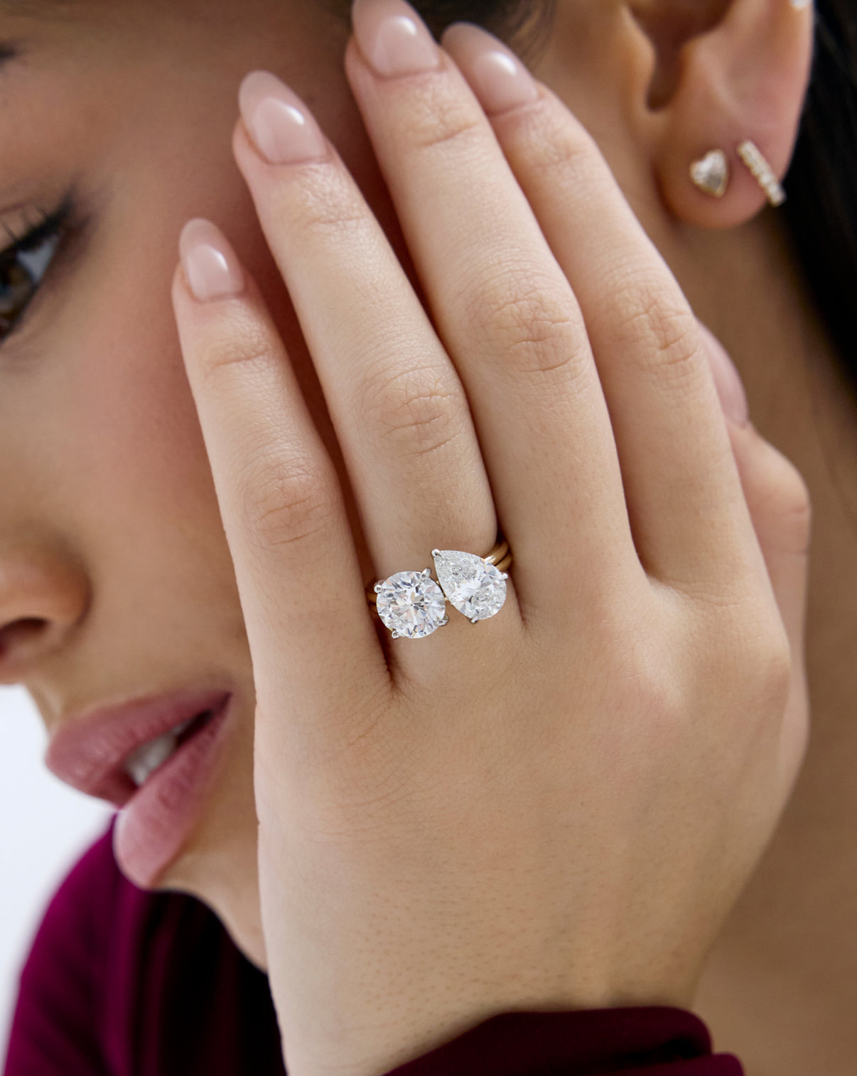close up of model wearing Stacked 4.74 Round & Pear Whisper Thin® Duet diamond engagement ring in 14K Yellow Gold