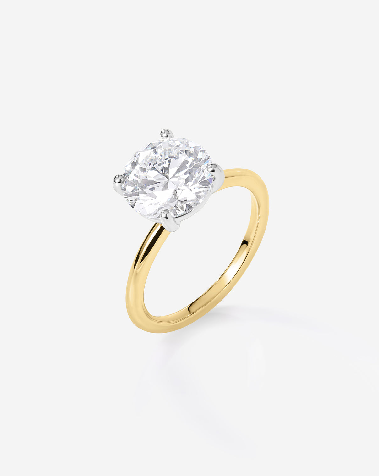 close up side view of 2.57 carat Round ring of the 4.70 Oval & Pear Whisper Thin® Duet diamond Engagement ring in 14K Yellow Gold