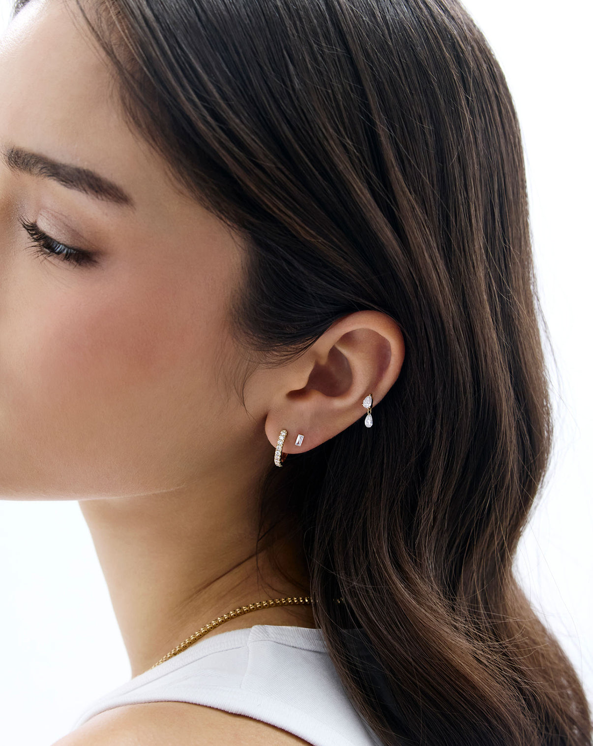 Model shown wearing the Pearl Drop Lab Diamond Flatback Earring styled with a diamond huggie and the mini emerald lab diamond flatback earring