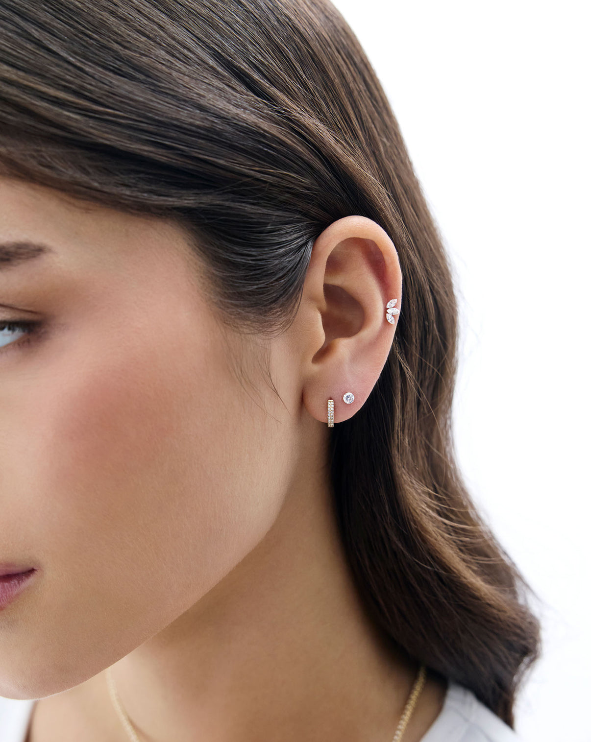 A model wearing the Marquise Lab Diamond flatback earring styled with a diamond huggie and the mini round lab diamond flatback earring