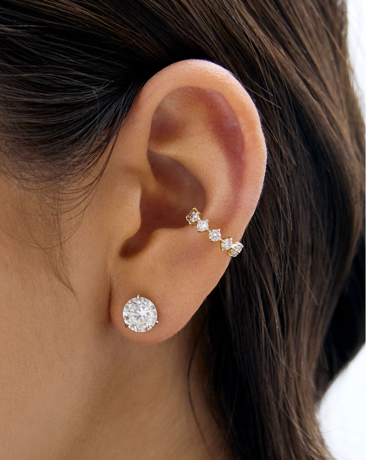 Starlight Lab Diamond Ear Cuff in 14K Yellow Gold shown on model's ear with a round diamond stud earring