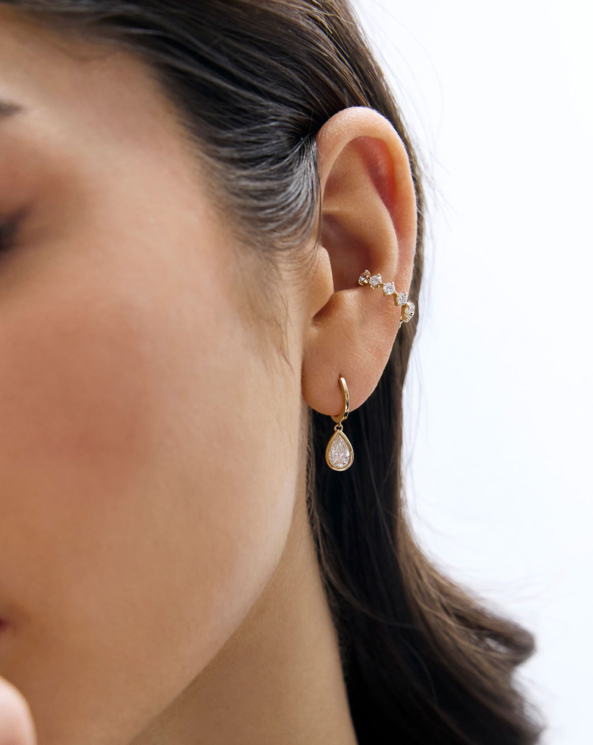 Model wearing Starlight Lab Diamond Ear Cuff styled with a framed pear diamond drop earring
