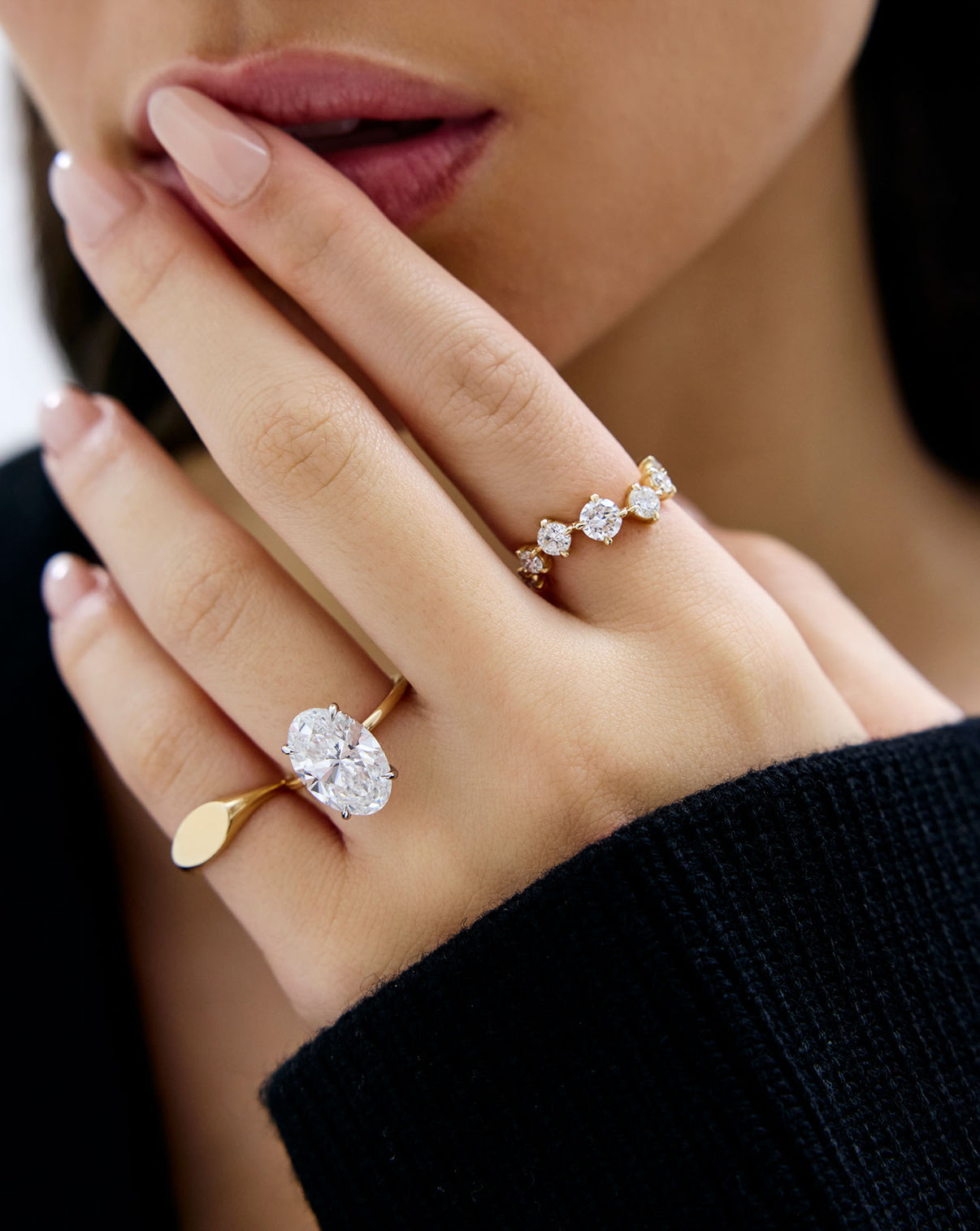 Starlight Lab Diamond Ring in 14K Yellow Gold styled on model's hand with an oval engagement ring and signet pinky ring