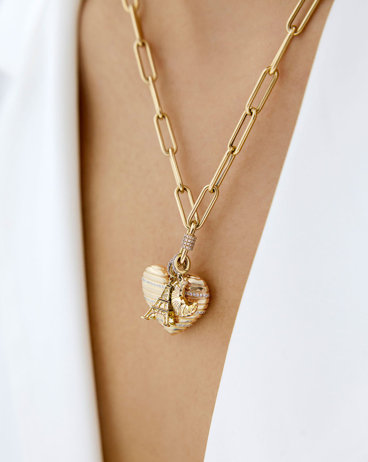 Croissant Charm being worn on chain by model paired with Eiffel Tower and heart charms